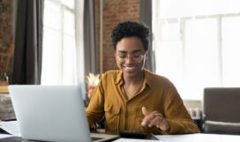Happy,Young,Afro,American,Entrepreneur,Woman,In,Glasses,Counting,Profit,